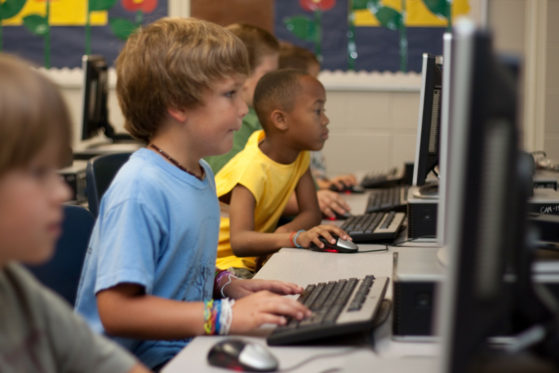 elementary male students learning at the computer